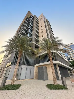a tall building with palm trees in front of it at Stylish 1BR in Dubai Hills - Pool, Gym & Near Dubai Hills Mall in Dubai