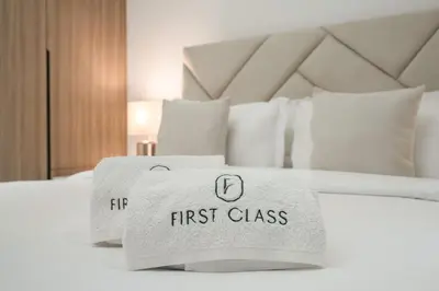 a hotel bed with a first class towel on it at Stylish 1BR in Dubai Hills - Pool, Gym & Near Dubai Hills Mall in Dubai
