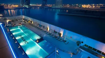 a swimming pool on a cruise ship at night at Spacious 2BR with Balcony, Stunning Burj Views & Steps from Bay Avenue Park in Dubai