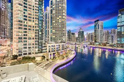 a view of a city with a river and buildings at Stylish Dubai Marina 2BR with Balcony, Pool, Gym Walk to Marina Walk & JBR in Dubai