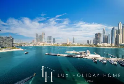 a view of a city with a marina in the water at LUX The Palace Beach Suite in Dubai
