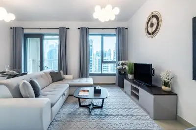 a living room with a couch and a tv at 29 Boulevard Tower 1 Apartment by GLOBALSTAY in Dubai