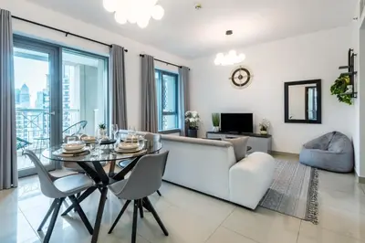 a living room with a table and a couch at 29 Boulevard Tower 1 Apartment by GLOBALSTAY in Dubai