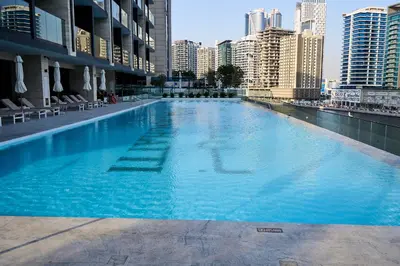 a large swimming pool in the middle of a city at Kazan Homes - Lux - Studio Close to Burj Khalifa & Dubai Mall - Business Bay in Dubai