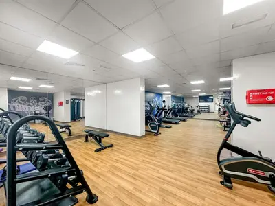a gym with rows of treadmills and ellipticals at FIRST CLASS Studio Classy Comfort in Dubai