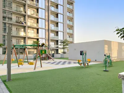 an empty playground in front of a building at Elegant 1BR Stay in Sobha Creek Luxury Apartment Near Dubai Canal in Dubai