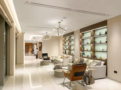 a lobby with couches and chairs and shelves at Elegant 1BR Stay in Sobha Creek Luxury Apartment Near Dubai Canal in Dubai