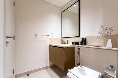 a bathroom with a sink and a mirror at Emaar Burj Crown - 1BR Sea View across from Burj Khalifa, walk to Dubai Mall in Dubai