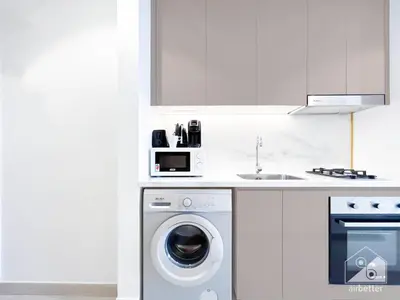 a kitchen with a washing machine and a sink at Luxury Living in Azizi Riviera l Cozy Balcony in Dubai