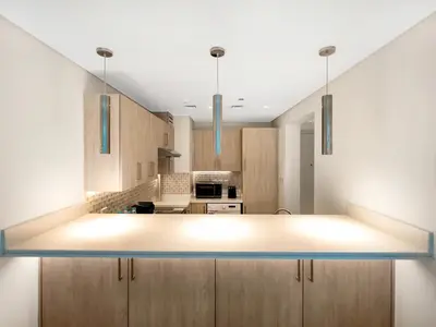 a kitchen with a large island in the middle at Palm Jumeirah Beachfront 1 Bedroom Apartment with Rooftop Infinity Pool and Atlantis Views in Dubai