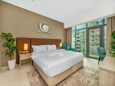 a bedroom with a large bed and a large window at Palm Jumeirah Beachfront 1 Bedroom Apartment with Rooftop Infinity Pool and Atlantis Views in Dubai