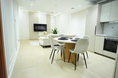 a kitchen and living room with a table and chairs at Stylish 1B in Heart of Marina Near Attractions in Dubai