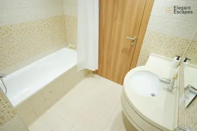 a bathroom with a toilet and a bath tub at Stylish 1B in Heart of Marina Near Attractions in Dubai