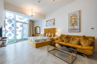 a living room with a bed and a couch at Millennium Binghatti Studio I Business bay I Studio in Dubai