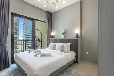 a hotel room with a large bed and a balcony at Sleek 1-Bedroom Getaway in Zada Tower in Dubai
