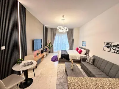 a living room with a couch and a bed at Enjoy our feel-home Appartement in Dubai