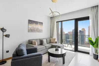 a living room with a couch and a table at VayK - Sleek & Stylish 1BR in Vida Dubai Marina in Dubai