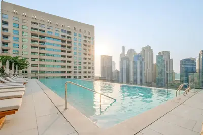 a swimming pool on the roof of a building at VayK - Sleek & Stylish 1BR in Vida Dubai Marina in Dubai