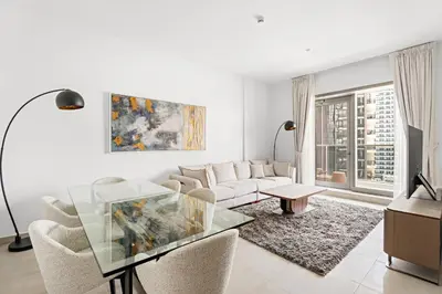 a white living room with a couch and a table at VayK - Premium 2BR Stay in Dubai Marina in Dubai