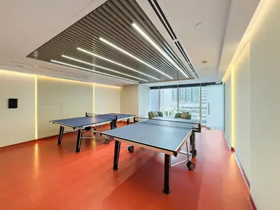 two ping pong tables in an empty room with tables at VayK - Comfortable Studio in JLT with Amazing Amenities in Dubai
