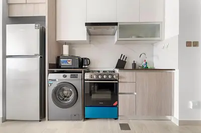 a kitchen with a refrigerator and a washing machine at VayK - Comfortable Studio in JLT with Amazing Amenities in Dubai