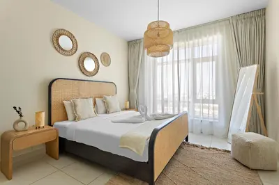 a bedroom with a large bed and a large window at VayK - Modern 1BR apartment in the Heart of Downtown Dubai in Dubai