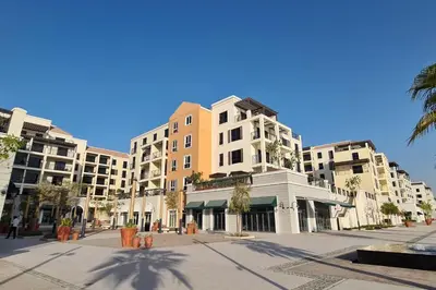 a street with tall buildings in a city at VayK - Modern 2BR with Stunning Sea View in Port de La Mer in Dubai