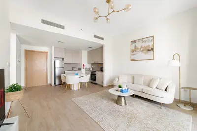 a white living room with a couch and a table at VayK - Stunning 1BR with Breathtaking Views in Dubai