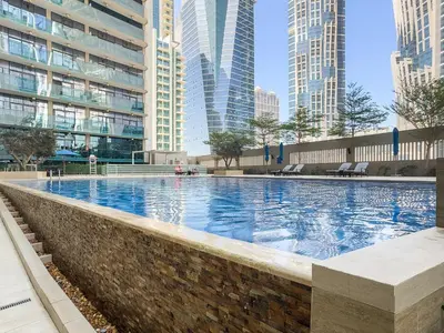 a swimming pool in a city with tall buildings at VayK - Modern 1BR Apartment in Business Bay in Dubai