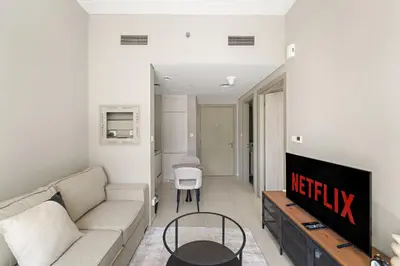 a living room with a couch and a tv at VayK - Stylish 1BR in Business Bay in Dubai