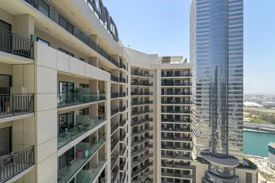 a tall apartment building with a view of the water at VayK - Stylish 1BR in Business Bay in Dubai