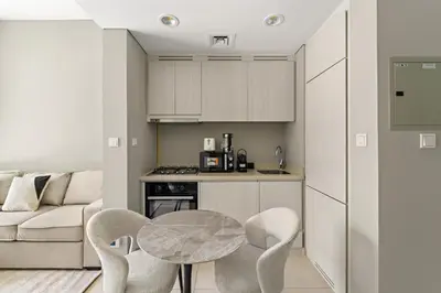 a kitchen with a table and chairs in a room at VayK - Stylish 1BR in Business Bay in Dubai
