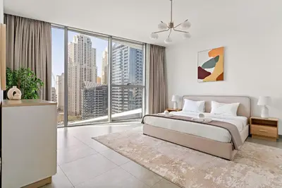 a bedroom with a large bed and a large window at VayK - Ocean View 1BR in the Heart of Dubai Marina in Dubai
