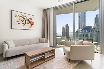 a living room with a couch and a chair at VayK - Ocean View 1BR in the Heart of Dubai Marina in Dubai