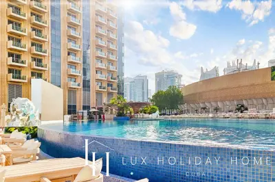 a large swimming pool in the middle of a city at LUX The JW Marina Suite 3 in Dubai
