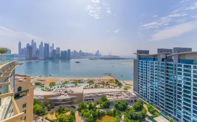 an aerial view of a city and a body of water at Highend Seven Palm 1BR Private Beach and Infinity Pool in Dubai