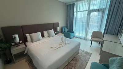a bedroom with a large bed with shoes on it at Highend Seven Palm 1BR Private Beach and Infinity Pool in Dubai