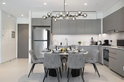 a kitchen with a table and chairs in a kitchen at SkyHigh Luxury 2BR Burj View Private Hot Tub Walk to DubaiMall in Dubai