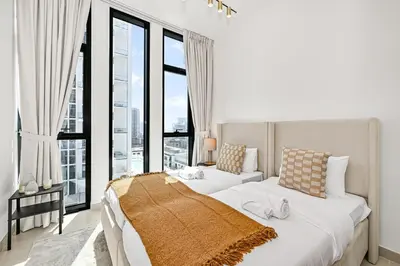 a bedroom with two beds and a large window at Stunning 2BDR Luxury Private Pool and Terrace in Dubai