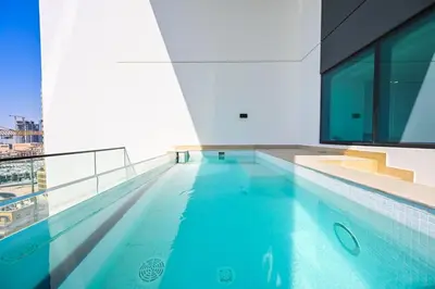 a swimming pool on the top of a building at Stunning 2BDR Luxury Private Pool and Terrace in Dubai