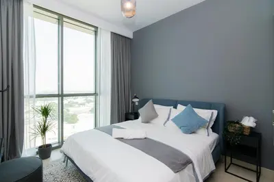 a bedroom with a large bed and a large window at Elite Escape Holiday Home - 1 BHK Getaway with Dubai Mall Access - 3310 in Dubai