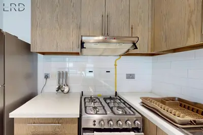 a kitchen with a stove and a counter top at Brand New & Modern 1BR Apartment in Dubai