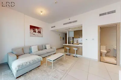 a living room with a couch and a table at Brand New & Modern 1BR Apartment in Dubai
