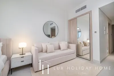 a living room with a white couch and a mirror at LUX Dubai Hills Sway Studio 2 in Dubai