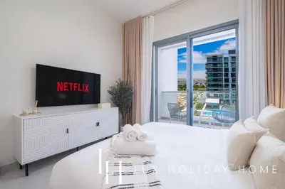 a white living room with a tv on a dresser at LUX Dubai Hills Sway Studio 2 in Dubai