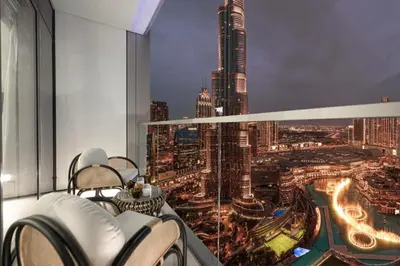 a room with a view of a city at night at SkyHigh 2BR Burj Views Steps to Dubai Mall in Dubai