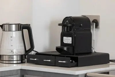a coffee pot sitting on top of a counter at SkyHigh 2BR Burj Views Steps to Dubai Mall in Dubai