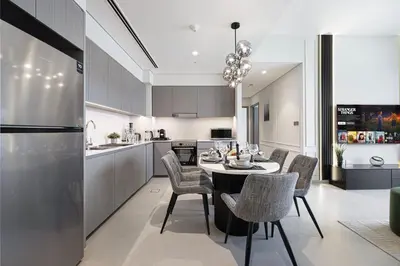 a kitchen and dining room with a table and chairs at SkyHigh 2BR Burj Views Steps to Dubai Mall in Dubai