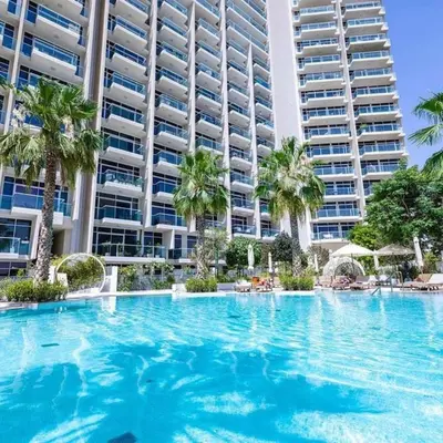 a large swimming pool in front of a large apartment building at Luxurious Spacious Studio in Dubai