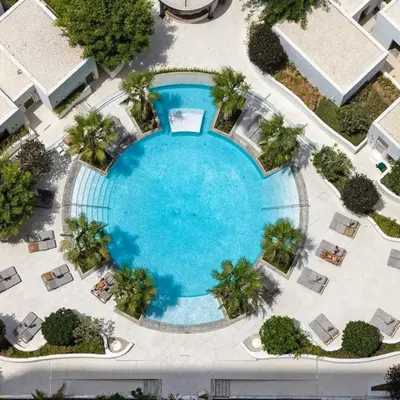 an overhead view of a large swimming pool with palm trees at Luxurious Spacious Studio in Dubai